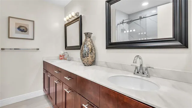 a bathroom with double vanity sink and a mirror