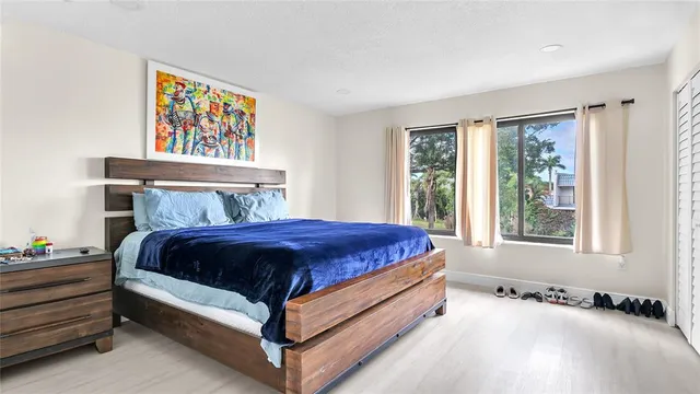 a bed sitting in a bedroom next to a window