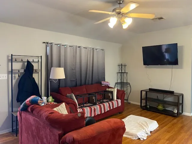 a living room with furniture and a flat screen tv