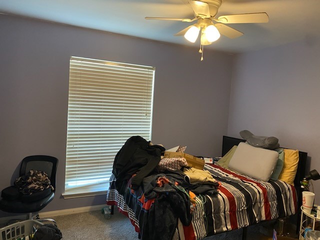 2303 North 12th Street Temple, TX 76501 - Photo 6 of 10 a bedroom with a bed and a chandelier