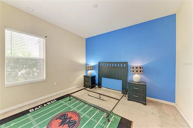 a bedroom with bed and a window