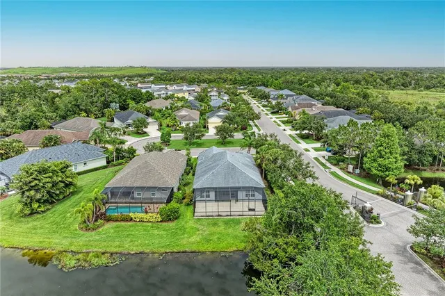 an aerial view of a house with a yard