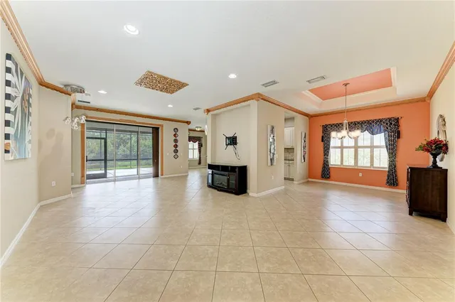 a view of an empty room with a fireplace and a window
