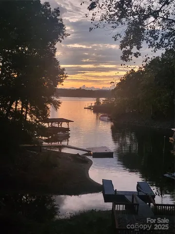 a view of house with backyard space and lake view