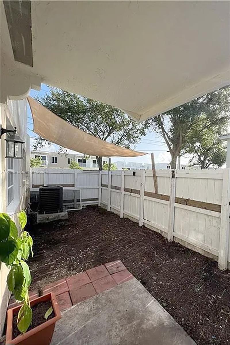 13990 Southwest 260th Street, Unit 101 Homestead, FL 33032 - Photo 11 of 34 a view of a backyard