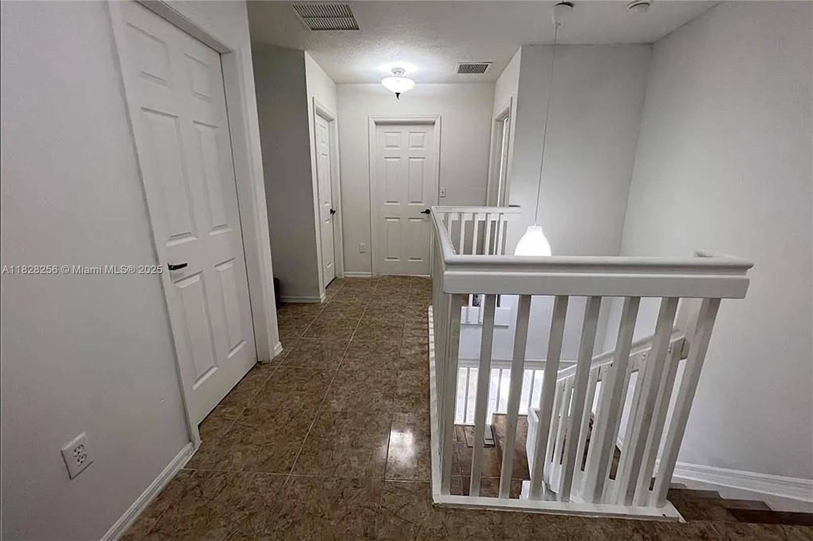 13990 Southwest 260th Street, Unit 101 Homestead, FL 33032 - Photo 21 of 34 a view of a hallway with wooden floor and entryway