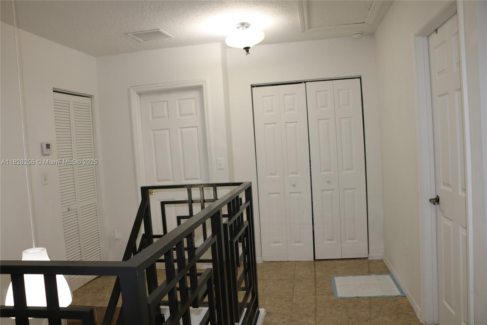 13990 Southwest 260th Street, Unit 101 Homestead, FL 33032 - Photo 33 of 34 a view of an entryway with wooden floor