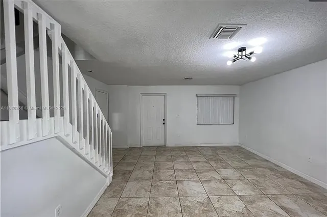 a view of an empty room with stairs