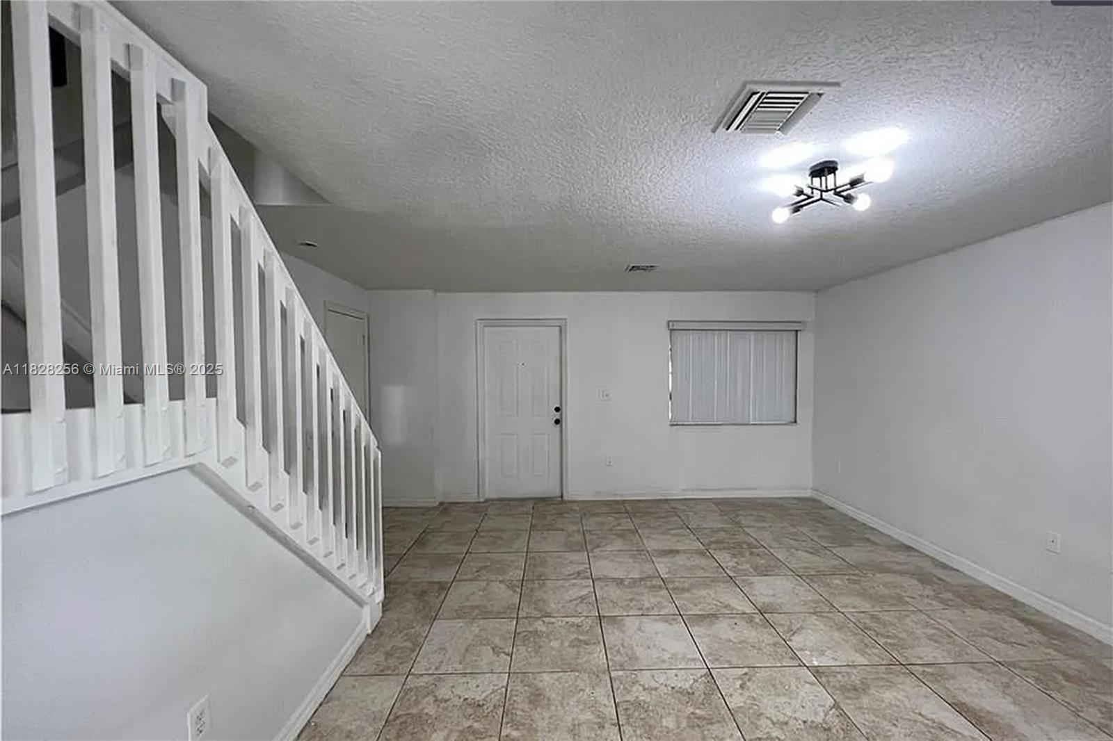 13990 Southwest 260th Street, Unit 101 Homestead, FL 33032 - Photo 4 of 34 a view of an empty room with stairs