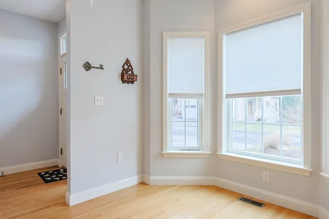 an empty room with windows and closet