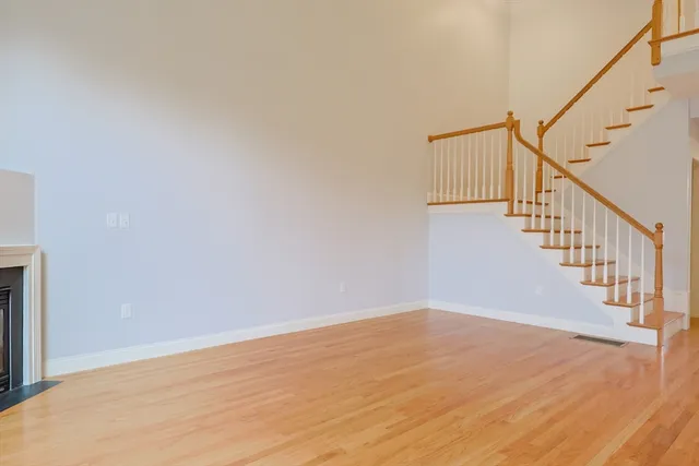 a view of room with stairs and wooden floor