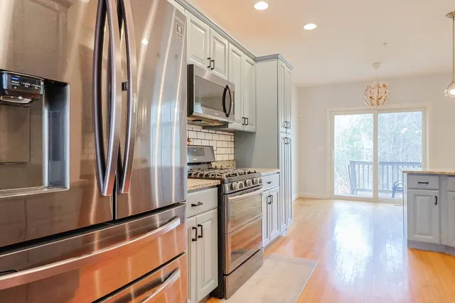 a kitchen with stainless steel appliances a refrigerator stove and sink