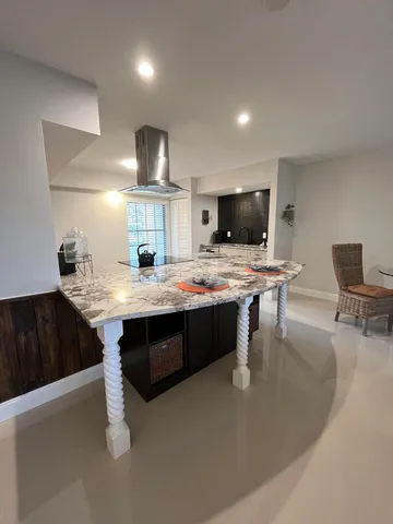 a view of kitchen with kitchen island sink and refrigerator