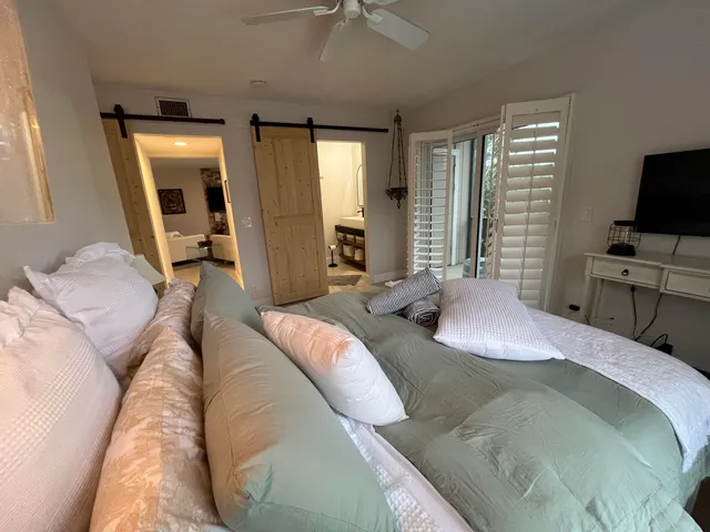 a bedroom with a large bed and a window