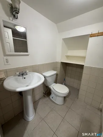 a bathroom with a sink a toilet and mirror