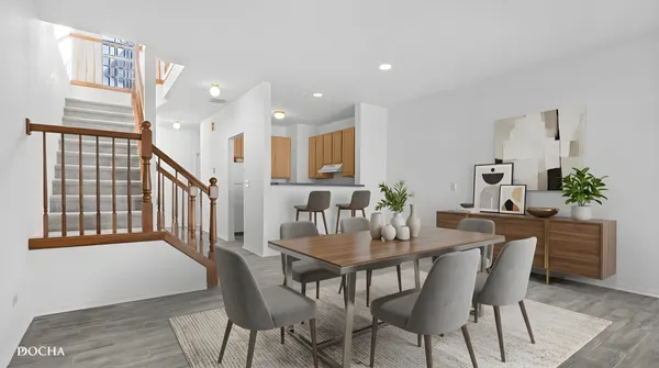 a dining room with furniture and wooden floor