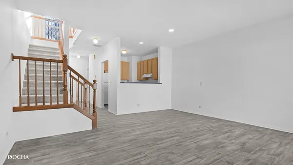 a view of an entryway with wooden floor