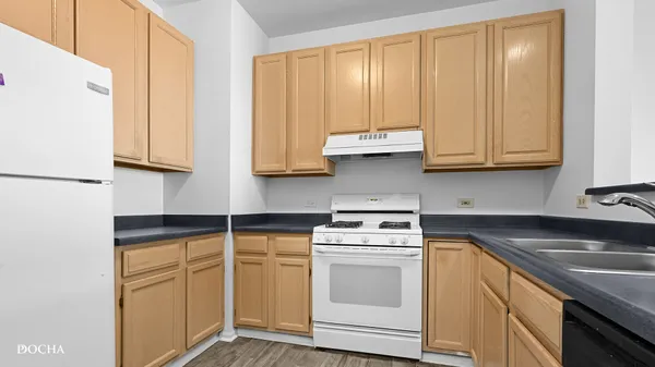 a kitchen with granite countertop cabinets stainless steel appliances and sink