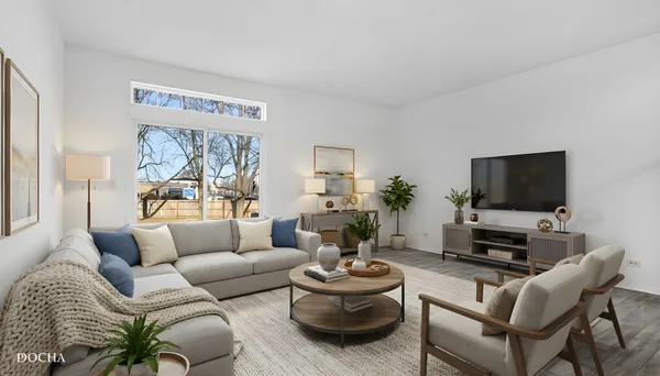 a living room with furniture a flat screen tv and a large window