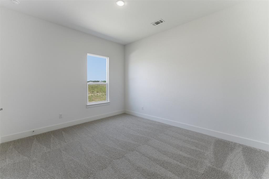 815 Vly Rdg Road Van Alstyne, TX 75495 - Photo 16 of 29 Room featuring neutral wall finishes, light gray carpeting, and a window with white trim