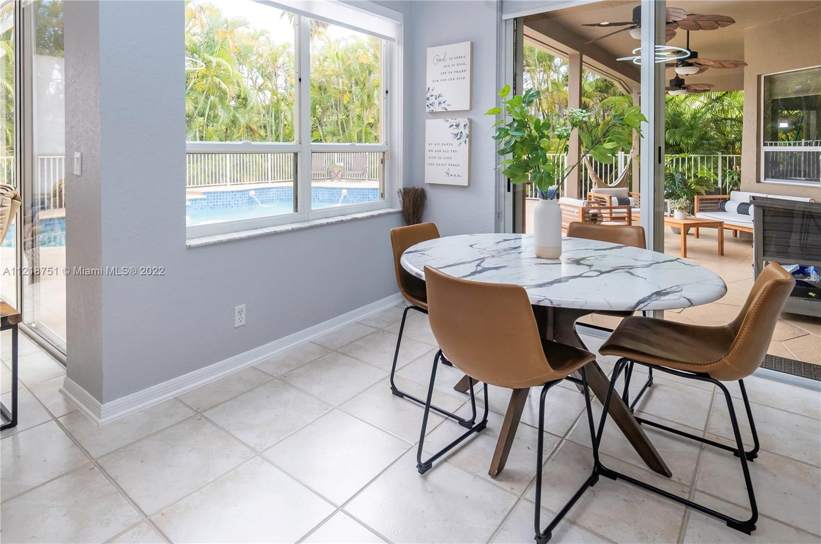 21432 Gosier Way Boca Raton, FL 33428 - Photo 16 of 55 a view of a dining room with furniture large windows and wooden fence