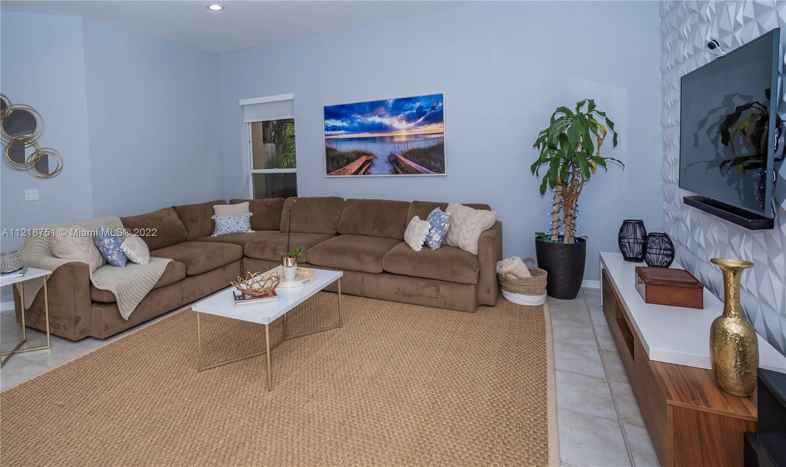 21432 Gosier Way Boca Raton, FL 33428 - Photo 23 of 55 a living room with furniture a couch and a flat screen tv