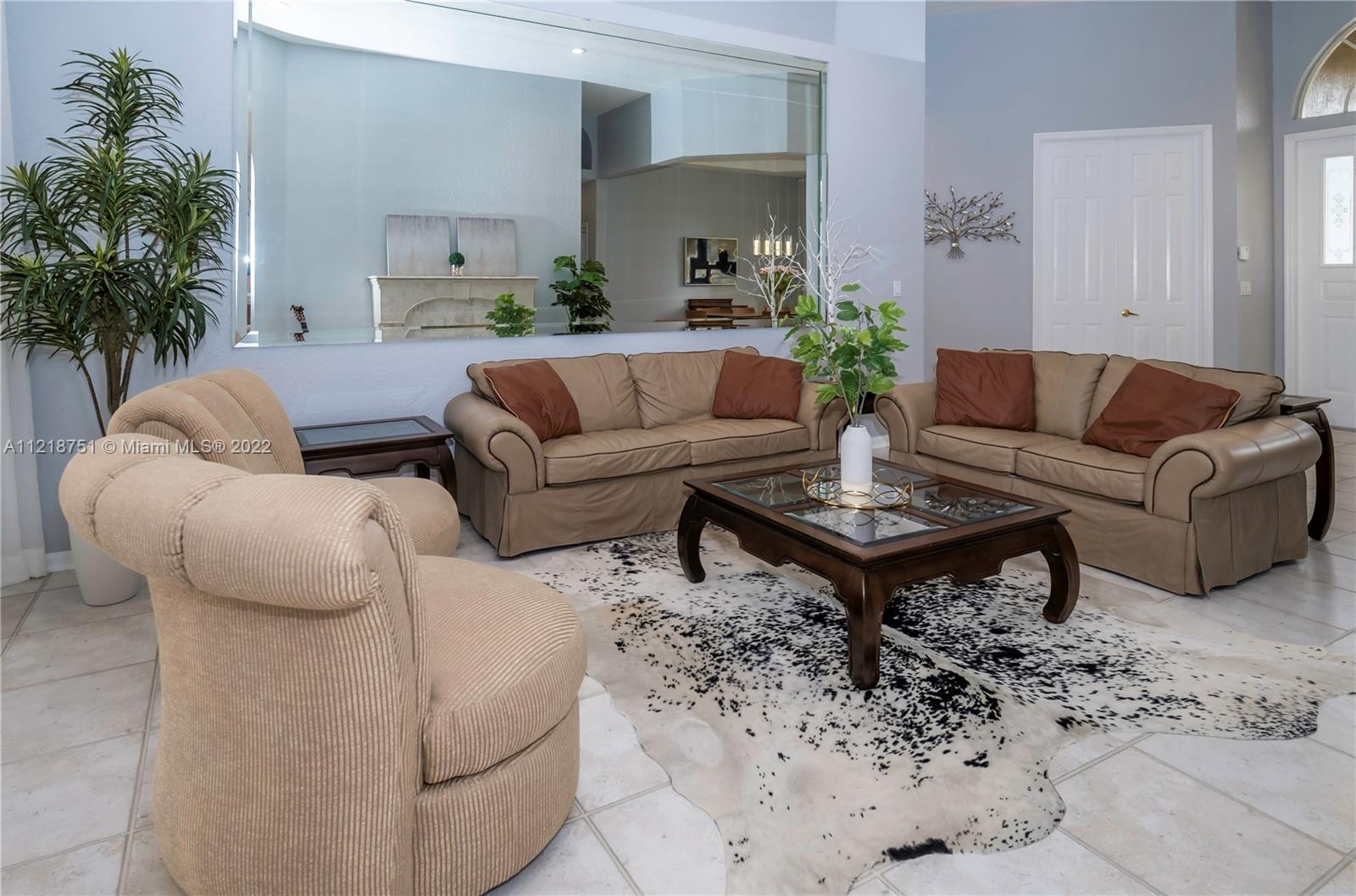21432 Gosier Way Boca Raton, FL 33428 - Photo 26 of 55 a living room with furniture a table and a potted plant