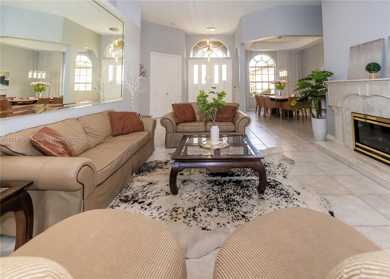21432 Gosier Way Boca Raton, FL 33428 - Photo 28 of 55 a living room with furniture a fireplace and a chandelier