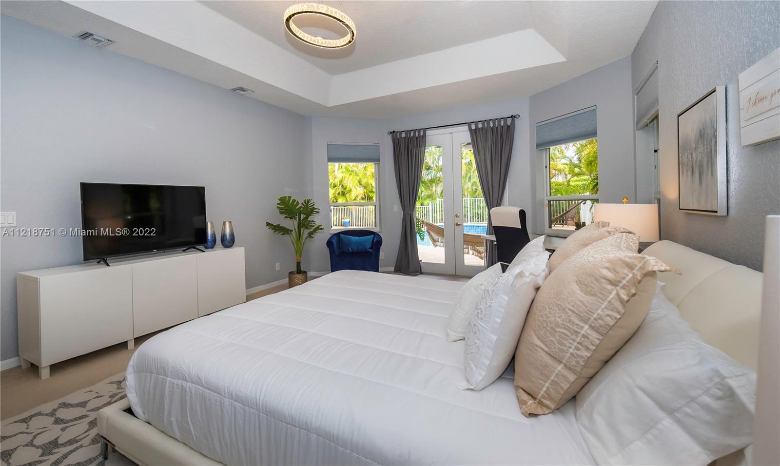 21432 Gosier Way Boca Raton, FL 33428 - Photo 33 of 55 a bedroom with a bed and a television