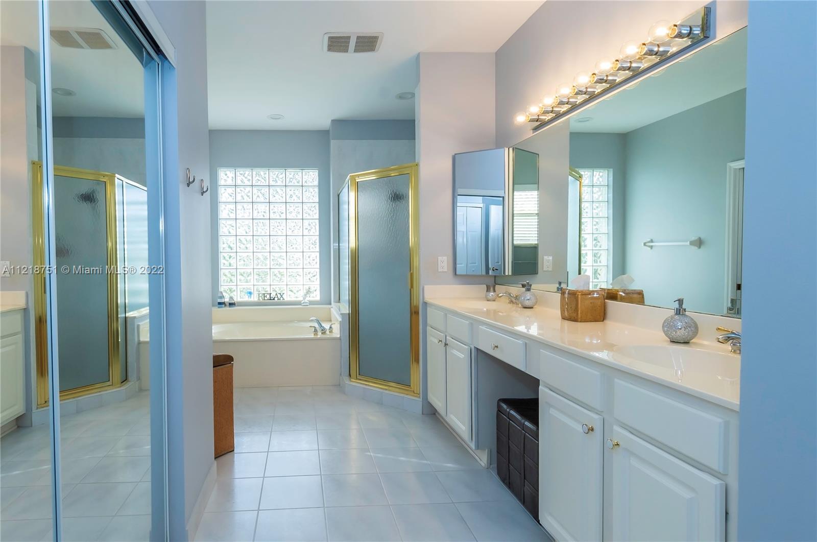 21432 Gosier Way Boca Raton, FL 33428 - Photo 36 of 55 a spacious bathroom with a granite countertop sink a mirror and a bathtub