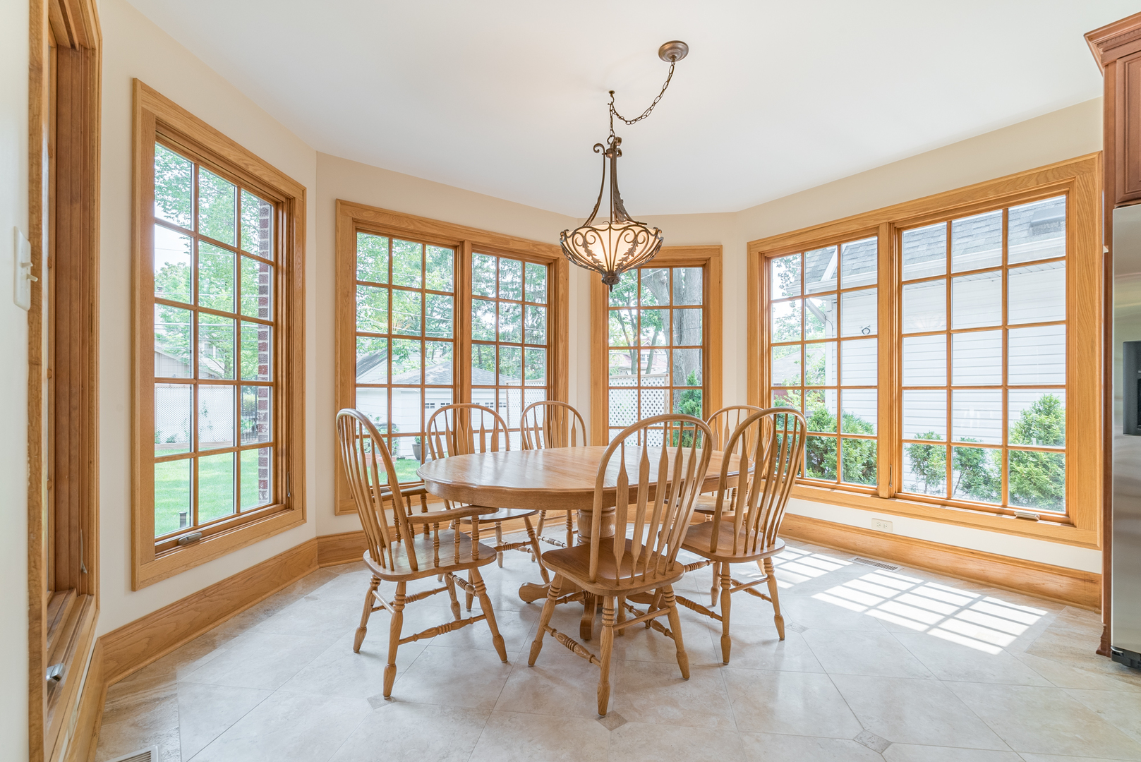 117 Elmore Street Park Ridge, IL 60068 - Photo 9 of 31 a dining room with furniture large windows and a chandelier