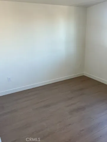 an empty room with wooden floor