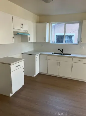 a kitchen with stainless steel appliances granite countertop a sink and a stove top oven