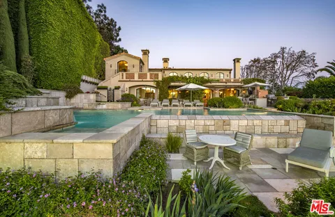 an aerial view of a house with a garden and plants