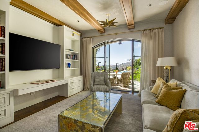 a bedroom with a large bed and large windows