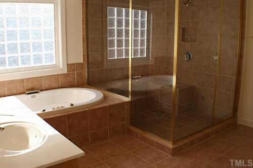 7220 Summit Waters Lane Raleigh, NC 27613 - Photo 3 of 11 a bathroom with a tub sink and shower