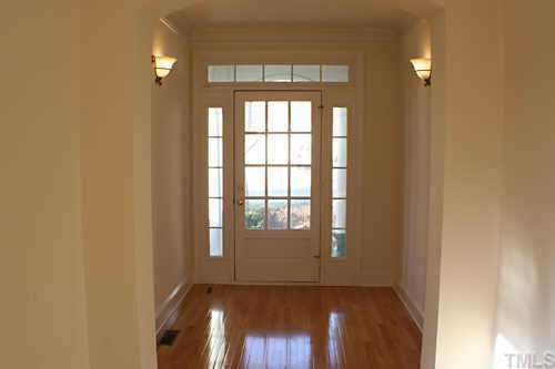 7220 Summit Waters Lane Raleigh, NC 27613 - Photo 7 of 11 an empty room with wooden floor and windows