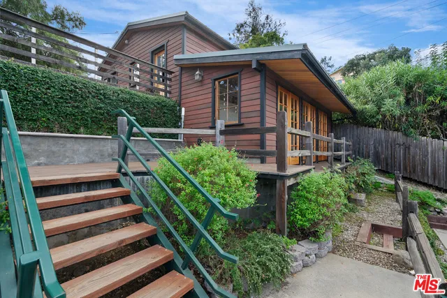 a view of balcony with wooden floor and fence