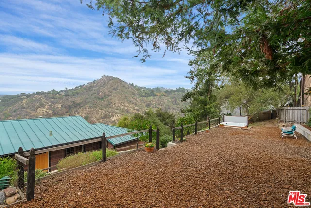 a view of backyard of house with seating space