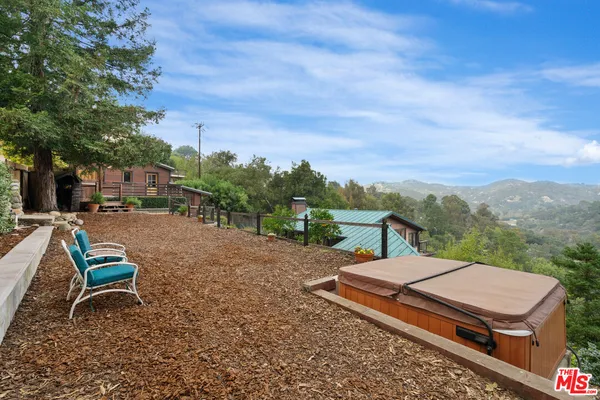 a view of a backyard with sitting area