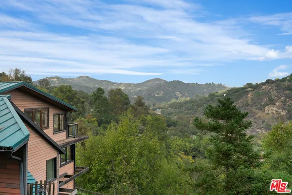 an aerial view of a house with outdoor space