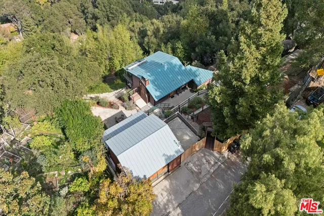 a view of a house with a backyard and trees
