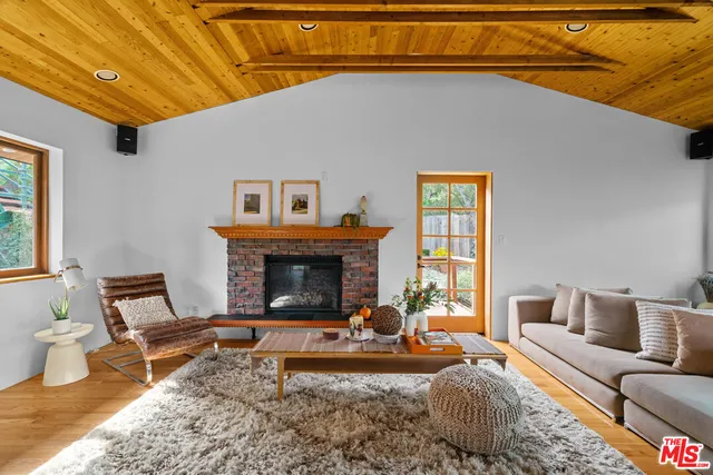 a kitchen with stainless steel appliances granite countertop a refrigerator a stove and a sink with wooden cabinets