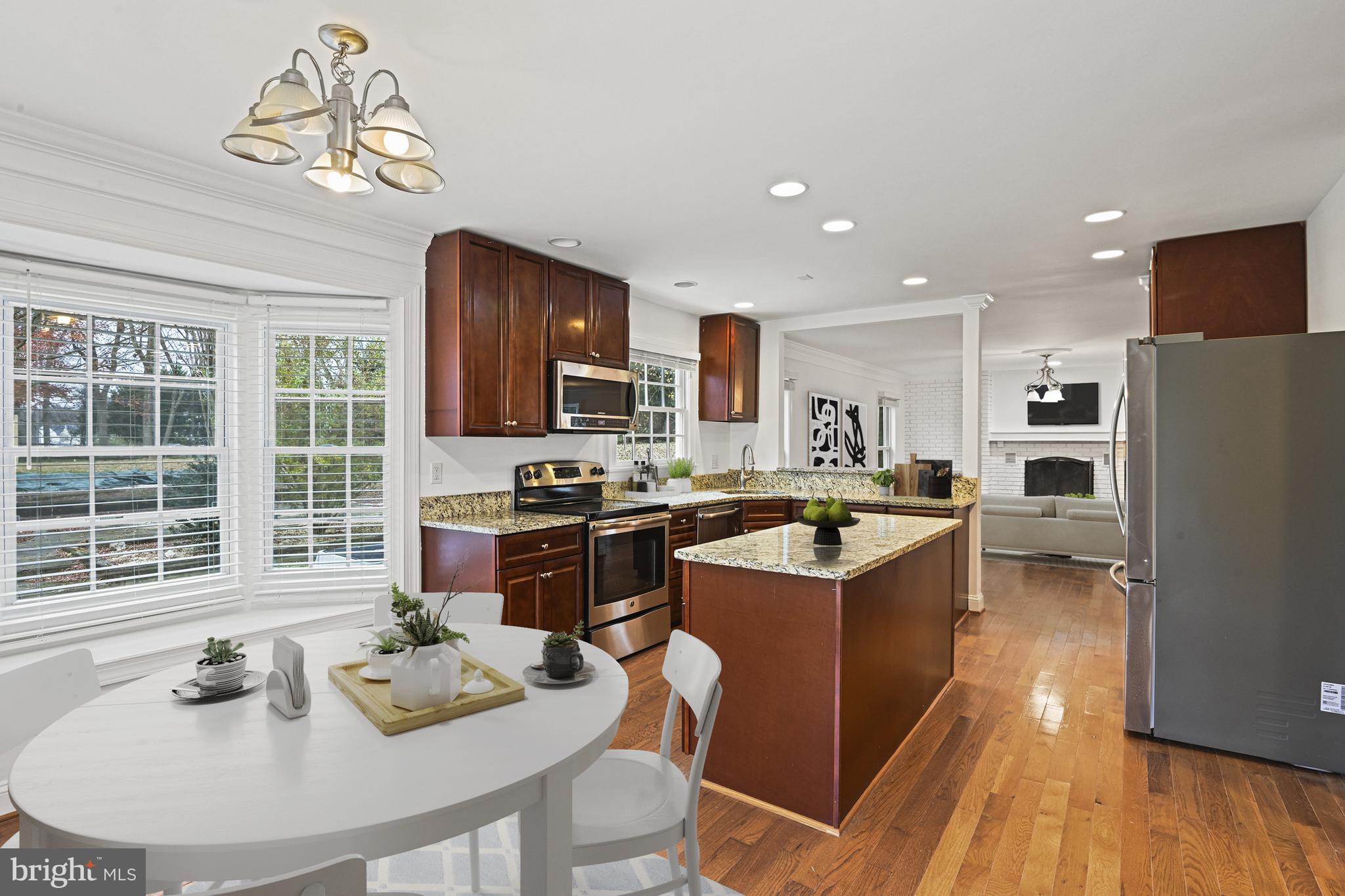 355 Springvale Road Great Falls, VA 22066 - Photo 11 of 37 a kitchen with a refrigerator a stove a sink dishwasher with a dining table and chairs