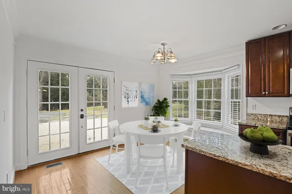 a kitchen with stainless steel appliances granite countertop a sink a stove and a wooden cabinets