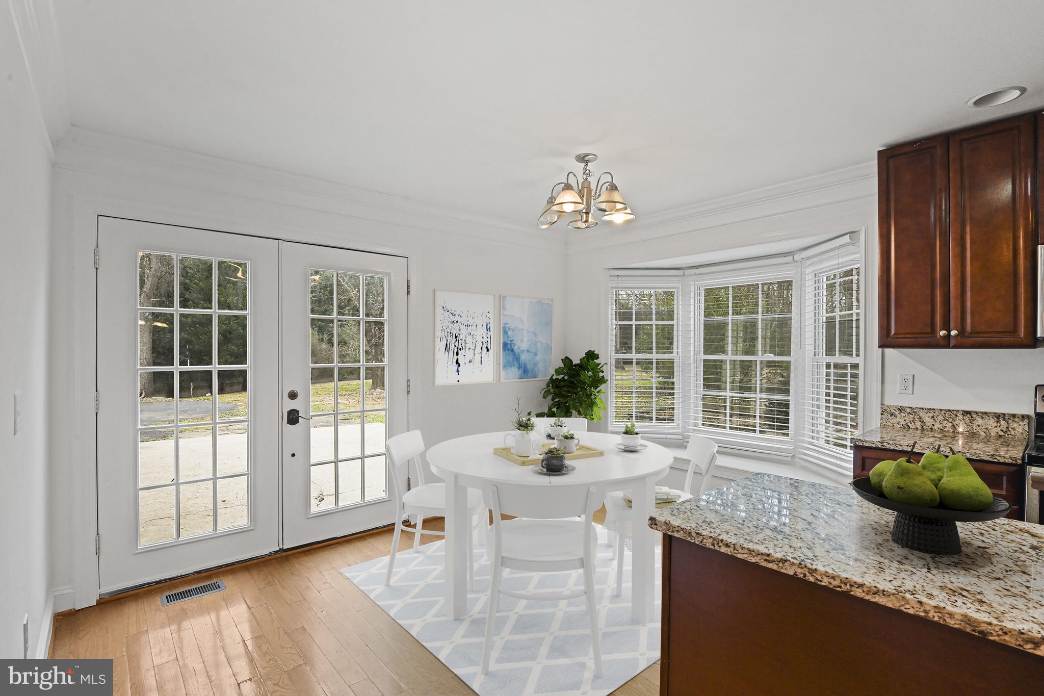 355 Springvale Road Great Falls, VA 22066 - Photo 12 of 44 a kitchen with stainless steel appliances granite countertop a sink a stove and a wooden cabinets