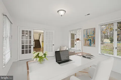 a living room with furniture and floor to ceiling windows