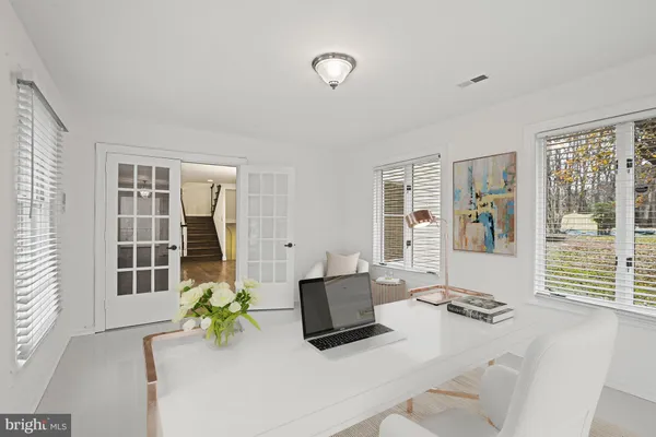 a living room with furniture and floor to ceiling windows
