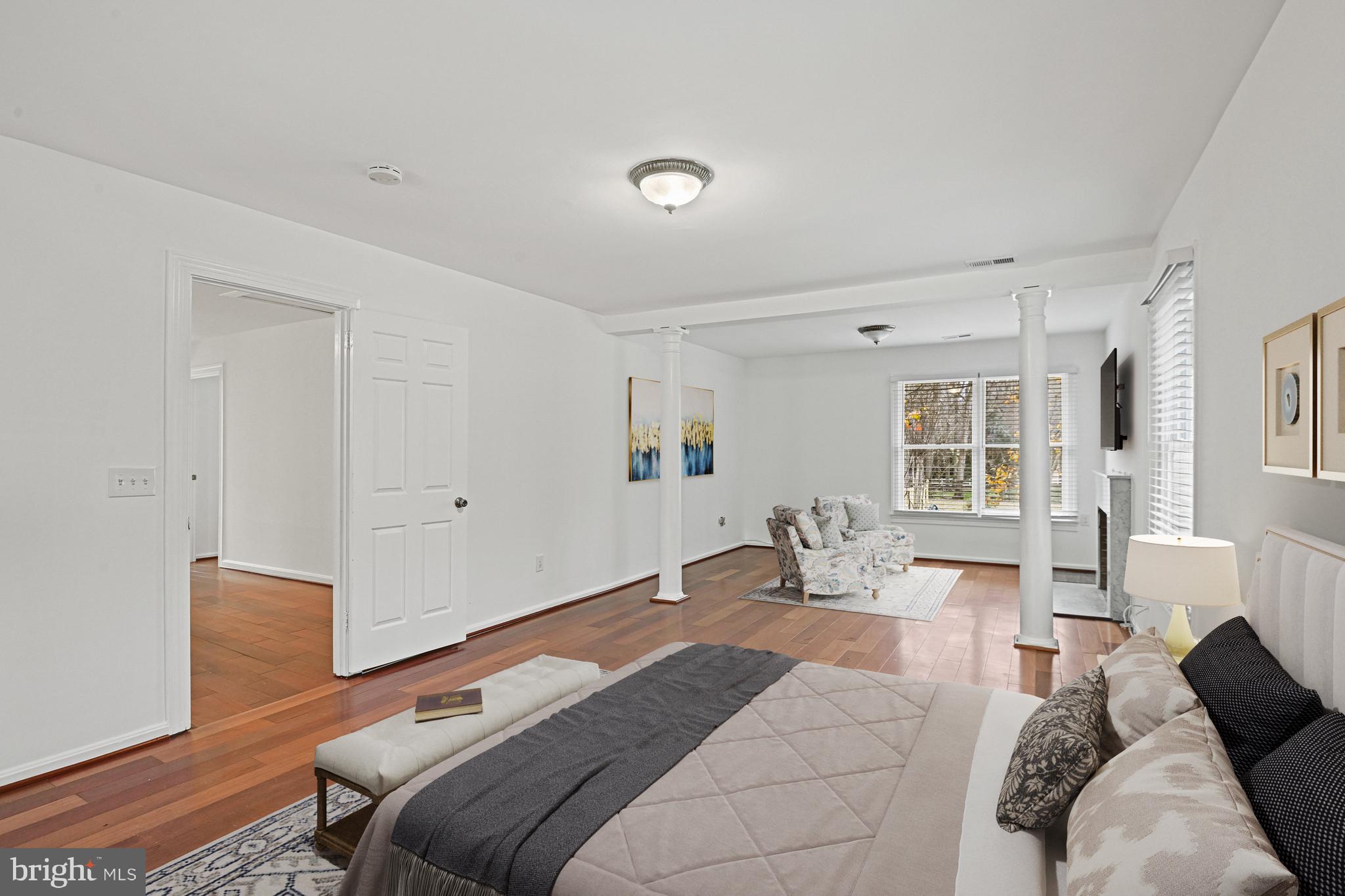 355 Springvale Road Great Falls, VA 22066 - Photo 20 of 44 a bedroom with a bed couch and wooden floor