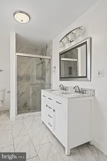 a bathroom with a sink a mirror and shower